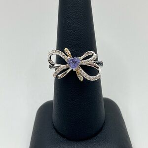 Elegant Silver and Gold Bow Ring with Purple Heart Gemstone